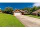 A cozy single-story red brick home with a two-car garage and a long concrete driveway at 511 Birmingham Ct, Rock Hill, SC 29732