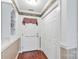 Hallway with wood floors, white trim, and convenient closet and shelving at 511 Birmingham Ct, Rock Hill, SC 29732