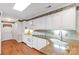 Bright kitchen with white cabinets, granite countertops, and stainless steel sink at 511 Birmingham Ct, Rock Hill, SC 29732