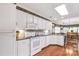 Bright kitchen features white cabinets, hardwood flooring, and access to a dining area at 511 Birmingham Ct, Rock Hill, SC 29732