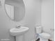 Stylish powder room features a pedestal sink, modern faucet, and a round mirror at 514 13Th Avenue Ne Dr, Hickory, NC 28601