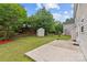 Spacious backyard with lush green lawn, patio, and storage shed at 516 Cool Creek Dr, Rock Hill, SC 29732