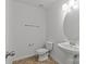 Well-lit bathroom with a pedestal sink, tile floors, and standard toilet at 516 Cool Creek Dr, Rock Hill, SC 29732