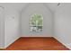 Bright bedroom featuring hardwood floors and large arched window at 516 Cool Creek Dr, Rock Hill, SC 29732