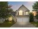 Charming two-story home with arched windows, a stone facade, and a two-car garage at 516 Cool Creek Dr, Rock Hill, SC 29732