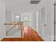 Bright upstairs hallway featuring wood floors, staircase, and natural light at 516 Cool Creek Dr, Rock Hill, SC 29732