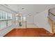 Bright living room featuring hardwood floors, staircase, and abundant natural light from large windows at 516 Cool Creek Dr, Rock Hill, SC 29732