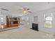 Open-concept living room flows into the kitchen, featuring a fireplace and large windows at 516 Cool Creek Dr, Rock Hill, SC 29732