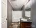 A clean bathroom with a shower-tub combination, vanity, and fixtures in a gray color palette at 5321 State Line Rd, Marshville, NC 28103