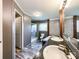 Bathroom with double sinks, glass shower, and neutral stone accents at 5321 State Line Rd, Marshville, NC 28103
