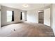 Bright bedroom offering neutral carpet, large windows with views, and a connecting door at 5321 State Line Rd, Marshville, NC 28103