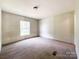 Simple bedroom with a window and neutral walls providing a relaxing and adaptable space at 5321 State Line Rd, Marshville, NC 28103