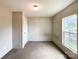 Neutral-toned bedroom offers carpeting and a window view, creating a serene atmosphere at 5321 State Line Rd, Marshville, NC 28103