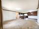 Spacious living room with carpet, leading to an open kitchen and dining area at 5321 State Line Rd, Marshville, NC 28103