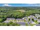Aerial view showcasing the townhouse community nestled amongst a vibrant green wooded area at 6000 Boathouse Ln # C, Cramerton, NC 28032