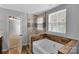 Bathroom featuring a tub with glass shower, neutral wall color and wood cabinets at 6000 Boathouse Ln # C, Cramerton, NC 28032