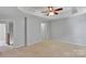 Spacious bedroom with carpeted floors, neutral walls and a tray ceiling with fan at 6000 Boathouse Ln # C, Cramerton, NC 28032