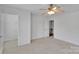 This bedroom offers neutral carpeting, a ceiling fan, and a walk-in closet at 6000 Boathouse Ln # C, Cramerton, NC 28032