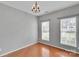 An empty dining room boasts gleaming hardwood floors and plenty of natural light at 6000 Boathouse Ln # C, Cramerton, NC 28032
