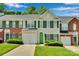 Charming townhouse with green door, shutters, an attached garage, and manicured lawn at 6000 Boathouse Ln # C, Cramerton, NC 28032