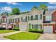 A well-maintained townhouse with a green door, attached garage and nice landscaping at 6000 Boathouse Ln # C, Cramerton, NC 28032