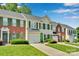 Attractive townhome exteriors with green shutters, fresh green lawns and lovely landscaping at 6000 Boathouse Ln # C, Cramerton, NC 28032
