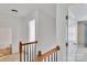 Bright hallway with wood railing, with access to bedrooms and bathroom at 6000 Boathouse Ln # C, Cramerton, NC 28032