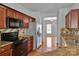 Functional kitchen featuring modern appliances and granite countertops overlooking adjacent dining room at 6000 Boathouse Ln # C, Cramerton, NC 28032