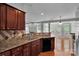 Kitchen with dark wood cabinetry, updated countertops and an open layout into the living room at 6000 Boathouse Ln # C, Cramerton, NC 28032