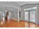 Open-concept living room featuring hardwood floors and bright, natural light from the glass doors at 6000 Boathouse Ln # C, Cramerton, NC 28032
