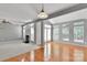 Inviting living space with fireplace, bright windows, and neutral carpet seamlessly connecting to hardwood floors at 6000 Boathouse Ln # C, Cramerton, NC 28032
