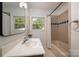Well-lit bathroom with tile shower and a large window offering outside views at 6259 River Cabin Ln, Charlotte, NC 28278