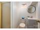 Clean bathroom featuring a shower, vanity, and a modern round mirror at 6259 River Cabin Ln, Charlotte, NC 28278
