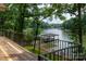 Wooden deck with a metal railing and a view of the lake at 6259 River Cabin Ln, Charlotte, NC 28278