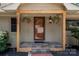 Charming front porch with decorative hanging plants and a welcome mat at 6259 River Cabin Ln, Charlotte, NC 28278