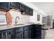 Stylish kitchen features dark cabinetry, granite countertops, and modern appliances at 6259 River Cabin Ln, Charlotte, NC 28278