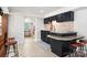 Contemporary kitchen boasts black cabinets, an eat-in bar, and an open layout to the rest of the home at 6259 River Cabin Ln, Charlotte, NC 28278