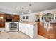 Modern kitchen open to living area, stainless appliances, granite counters, and breakfast bar at 6259 River Cabin Ln, Charlotte, NC 28278