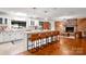 Open-concept kitchen with a large island, bar seating, and seamless flow into the living area at 6259 River Cabin Ln, Charlotte, NC 28278