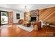 Cozy living room with wood accents, a stone fireplace, and comfortable seating at 6259 River Cabin Ln, Charlotte, NC 28278