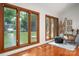 Living room showcasing large windows overlooking the lake with a view of the dock and lush trees at 6259 River Cabin Ln, Charlotte, NC 28278