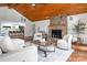 Inviting living room featuring a stone fireplace, wood ceiling, and comfortable seating arrangement at 6259 River Cabin Ln, Charlotte, NC 28278