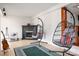 Relaxing space featuring hanging chairs, a fireplace, and stylish decor, creating a cozy ambiance at 6259 River Cabin Ln, Charlotte, NC 28278