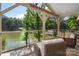 Inviting screened patio with comfortable chairs overlooking the calm lake at 6259 River Cabin Ln, Charlotte, NC 28278