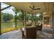 Inviting covered patio with slate tile, ceiling fan, and picturesque lake views for seamless indoor-outdoor living at 6259 River Cabin Ln, Charlotte, NC 28278