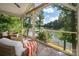 Relaxing screened patio featuring comfortable seating and a view of the lake at 6259 River Cabin Ln, Charlotte, NC 28278