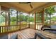 Charming screened-in porch with scenic views of the lake and comfortable seating at 6259 River Cabin Ln, Charlotte, NC 28278