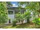 Lush backyard with covered deck, patio, and surrounded by mature trees and landscaping at 7011 Chateau Bordeaux Ln, Charlotte, NC 28270