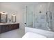 Luxurious bathroom with a soaking tub, glass-enclosed shower, and dual vanities at 7011 Chateau Bordeaux Ln, Charlotte, NC 28270