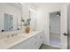 Bathroom featuring double sinks with stylish faucets and a view into the bedroom at 7011 Chateau Bordeaux Ln, Charlotte, NC 28270